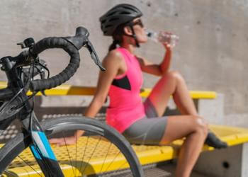 woman cyclist taking a water break